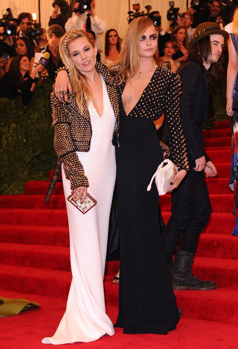 Cara delevingne and sienna miller wearing burberry to the costume institute gala benefit, metropolitan museam of art, new york. 06 may 2013